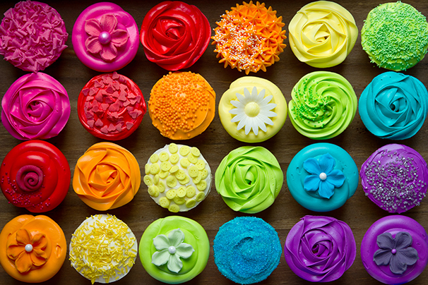 Rainbow coloured cupcakes.