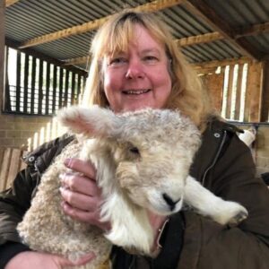 head and shoulders image of sarah holding a lamb